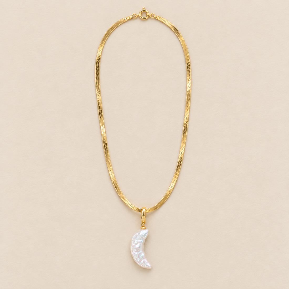 Selene 18K Gold-Plated Moon Pearl Necklace on a warm beige background