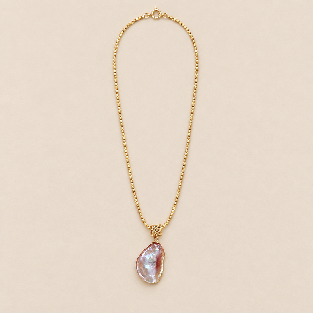 Opaline Sterling Silver Iridescent Baroque Pearl Necklace on a warm beige background