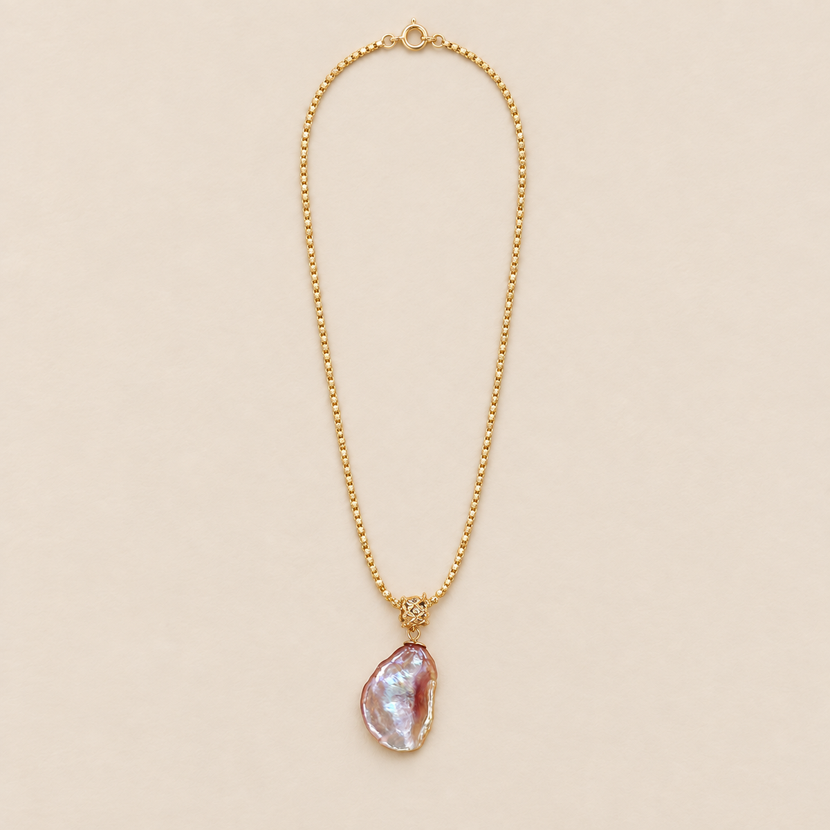 Opaline Sterling Silver Iridescent Baroque Pearl Necklace on a warm beige background
