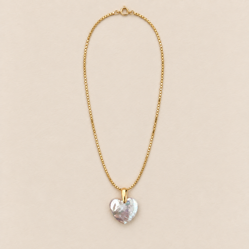 Amelie 18K Gold-Plated Heart Pearl Necklace on a warm beige background