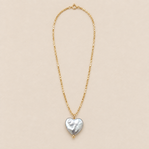Amelie 18K Gold-Plated Heart Baroque Pearl Necklace on a warm beige background