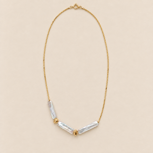 Aurelle 18K Gold-Plated Triple Baroque Pearl Necklace on a warm beige background